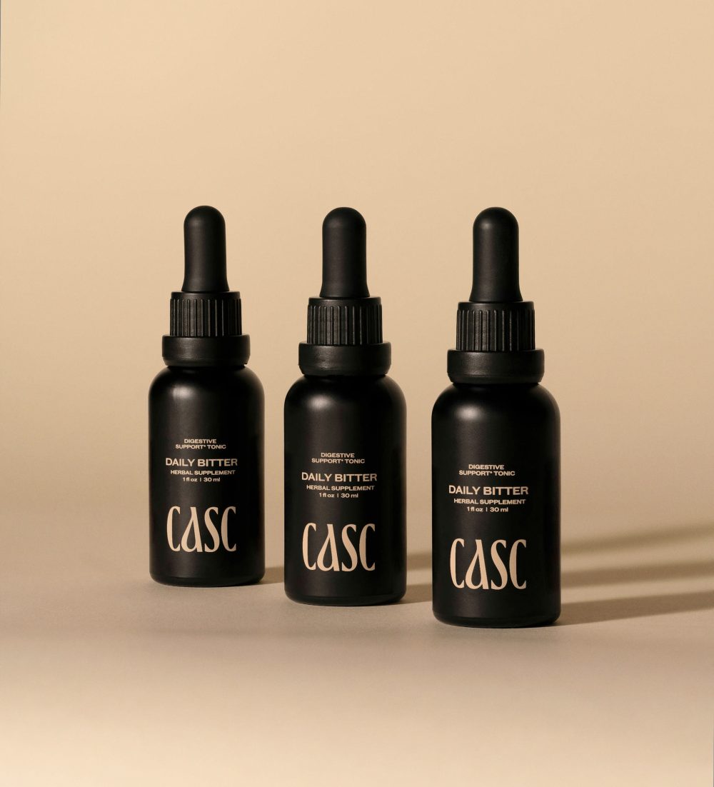 CASC Digestive Support Tonic, Daily Bitter black dropper bottles, cream background