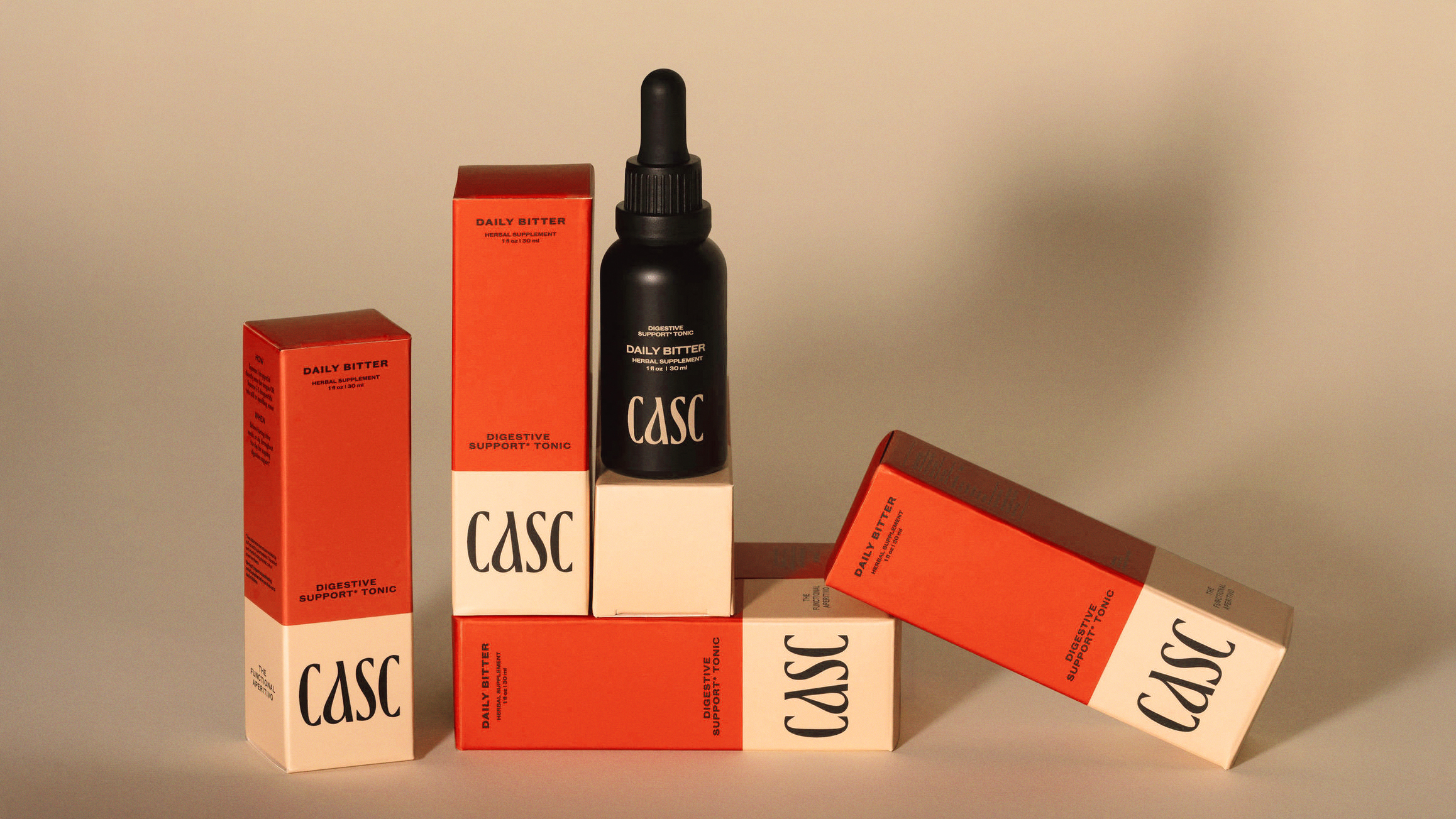 CASC Digestive Support Tonic, Daily Bitter Red Packaging Boxes with black dropper bottle, cream background
