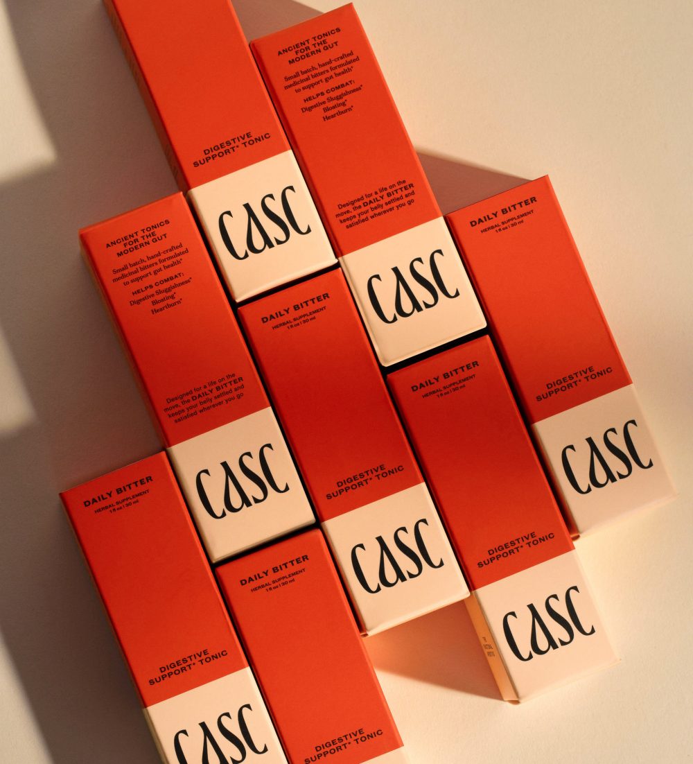 CASC Digestive Support Tonic, Daily Bitter Red Packaging Boxes, cream background