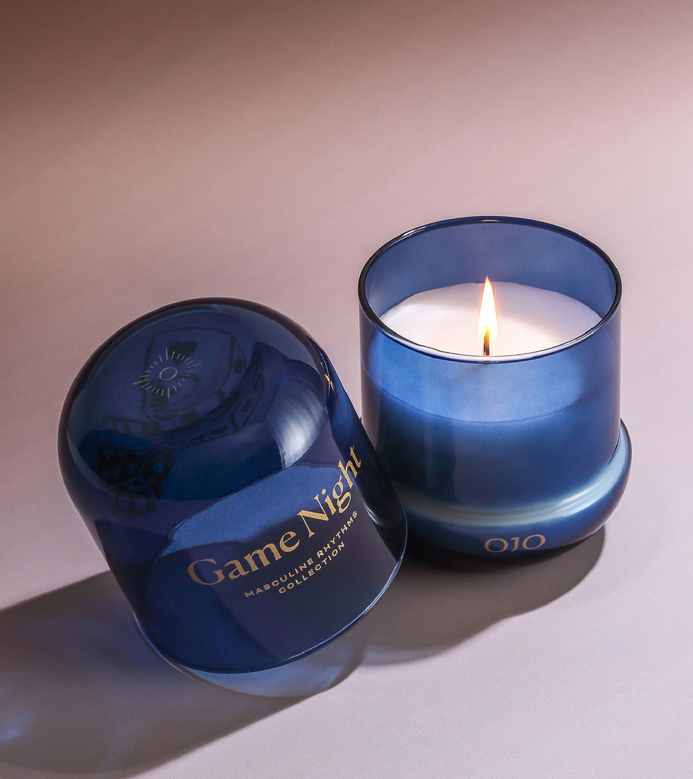 OJO Game Night candle collection with blue glass jar and white background