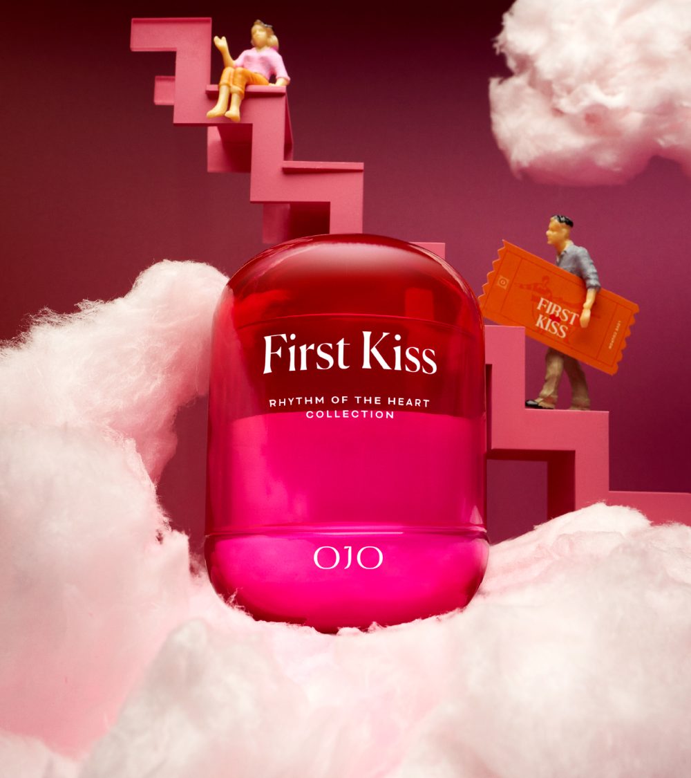 OJO First Kiss candle collection with gradient colored glass jar, white clouds, stairs and pink background