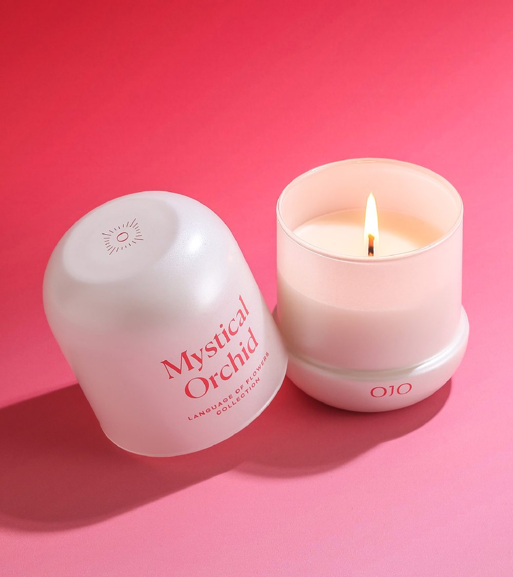 OJO Mystical Orchid candle with white glass jar and pink background